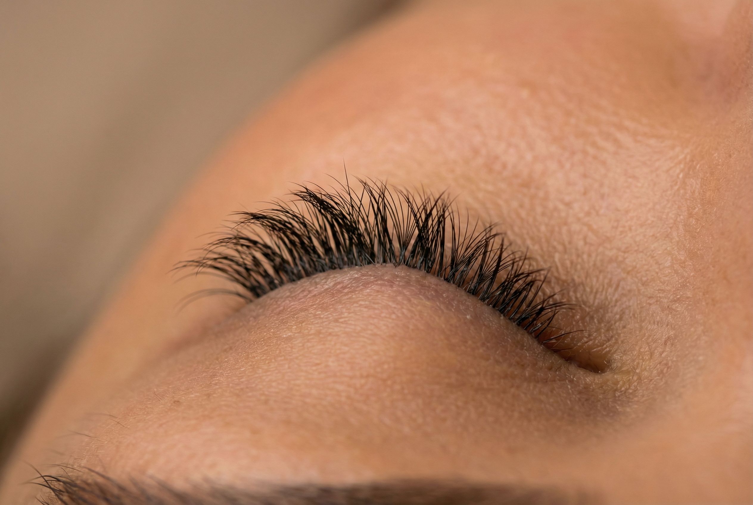 Close-up of hybrid lash extensions showing a textured mix of classic and volume fans