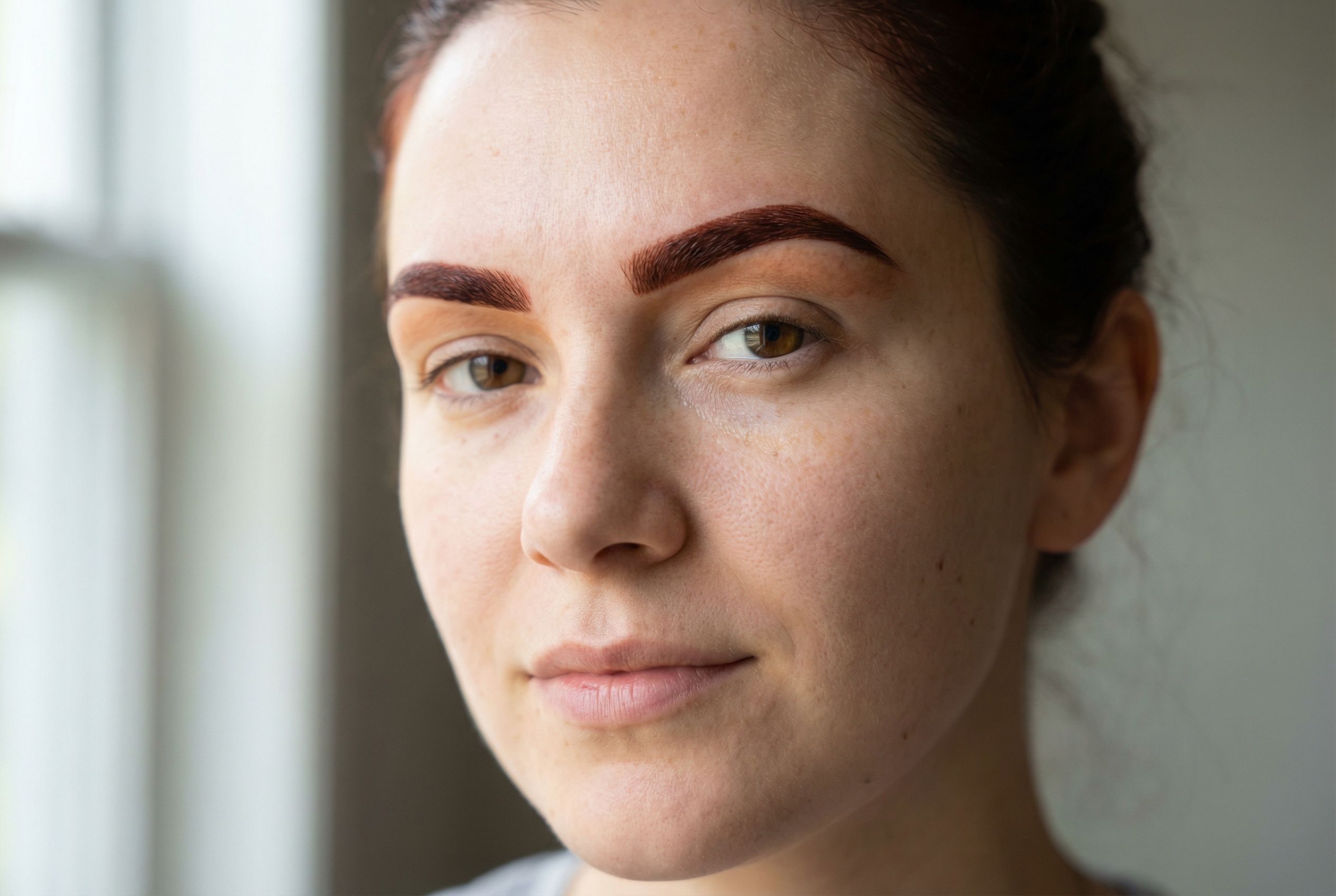 Close-up of beautifully finished henna brows showing rich color and natural filled-in effect